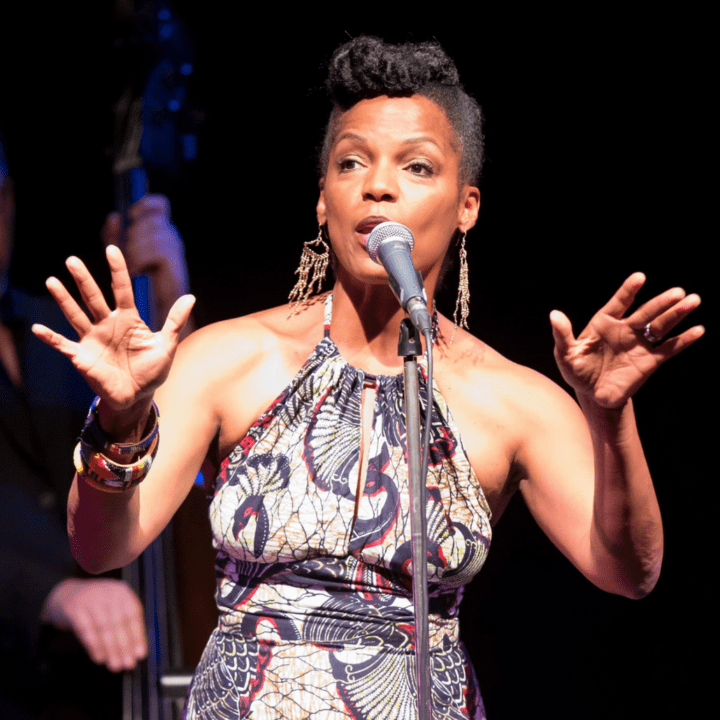 Vocalist Nnenna Freelon in front of a microphone.