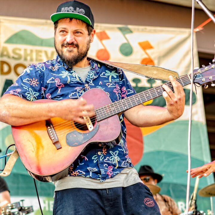 Josh Phillips playing a guitar