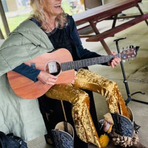LEAF Board member Annie Wenz playing guitar at LEAF Festival October 2025